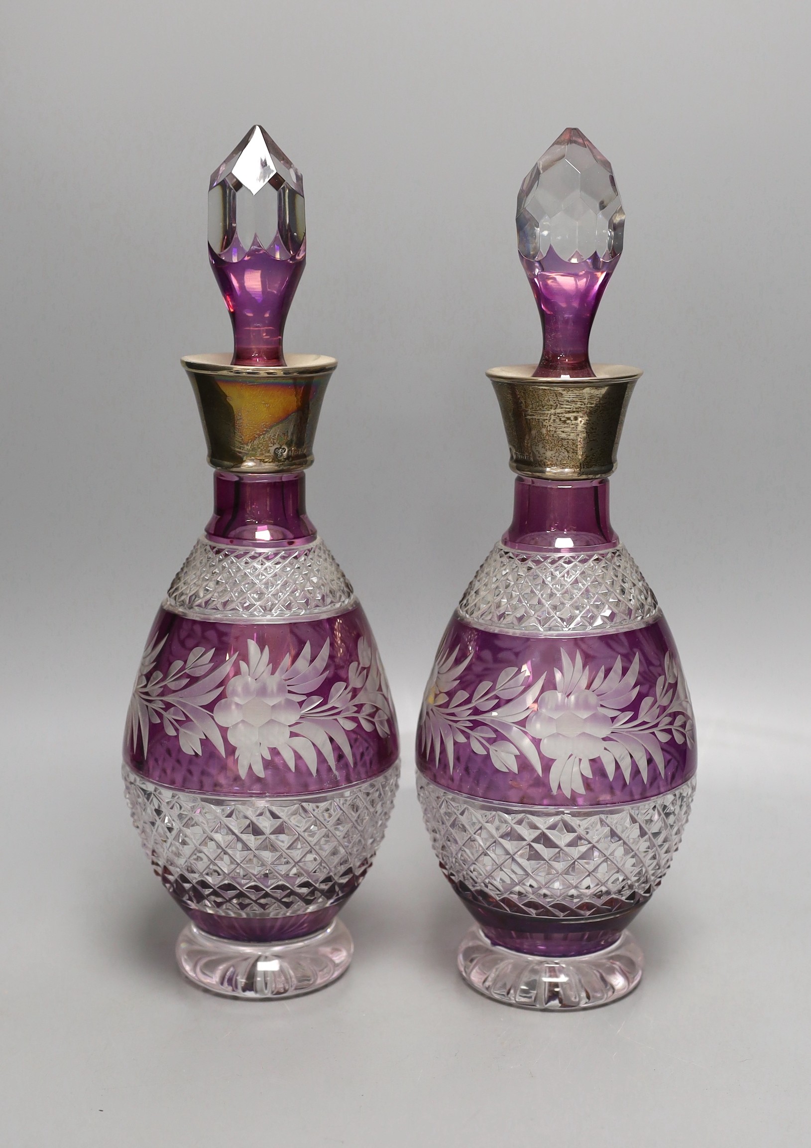 A pair of Bohemian silver mounted cut and amethyst flashed glass decanters and stoppers, 33cm